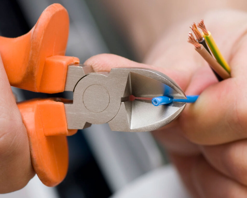 Close up of an electrician cutting wires | Experienced Electricians in Howden, Kendra Electrical Services Ltd