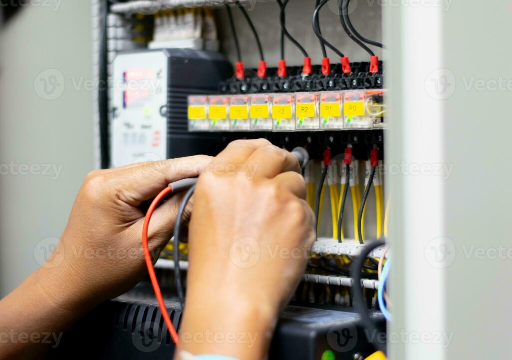 close-up of an electrician working in a fuse box | Electrician Howden