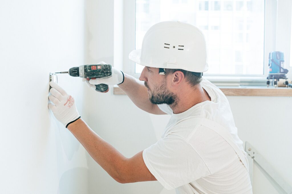 An electrician fitting a wall socket | Electrician Pontefract - Kendra Electrical.
