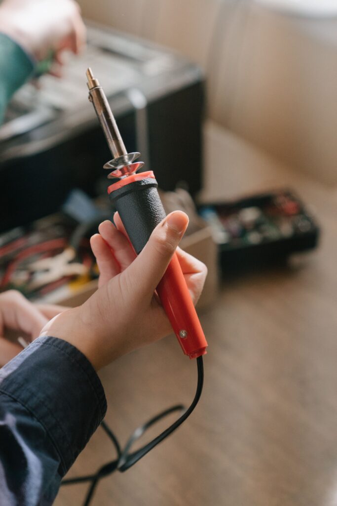 An electrician's hands at work | Kendra Electrical Services